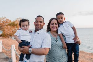 Family of four pose together