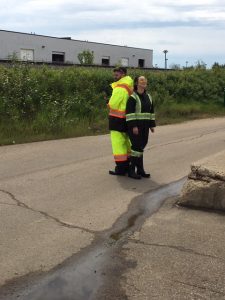 Two workers in hi viz, fire resistant rain wear